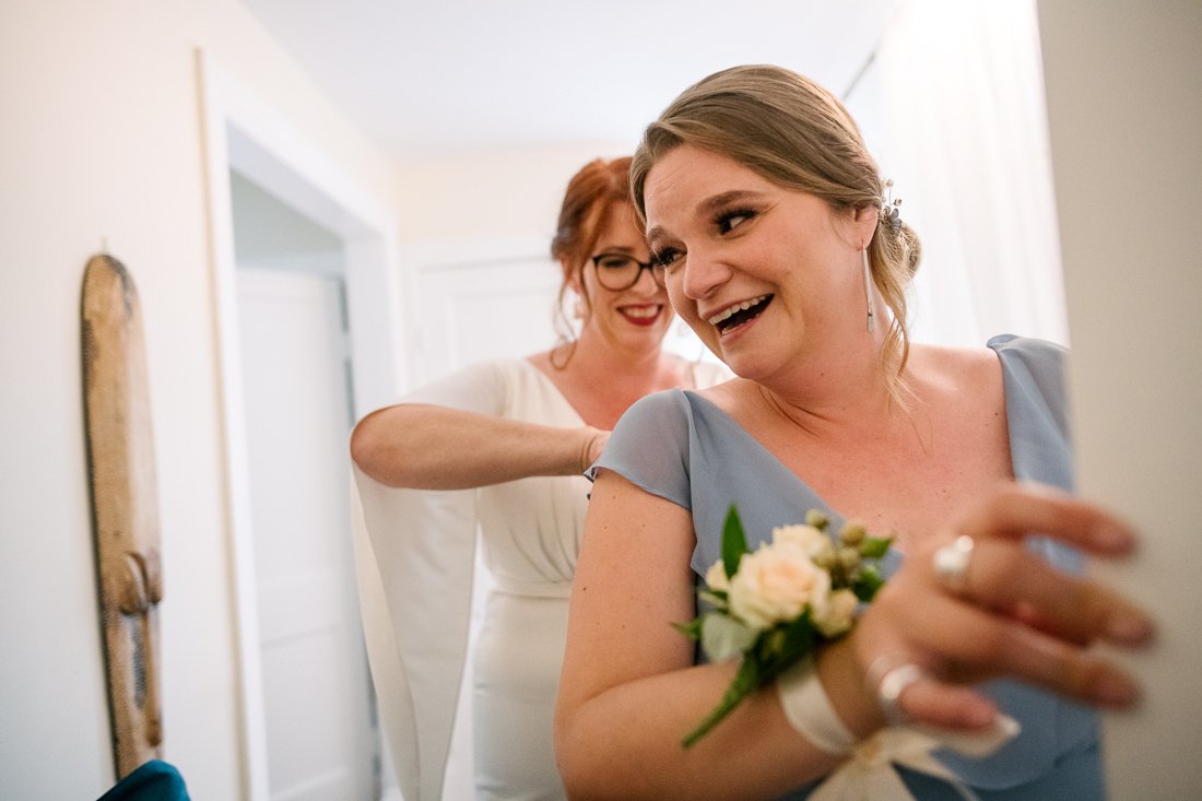Bride getting ready on her wedding with her bridesmaid