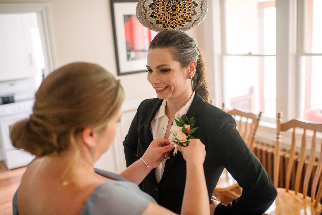 Bride getting ready for her wedding with her bridesmaid