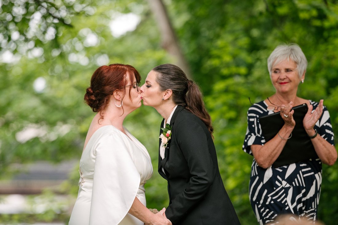 Brides kissing each other at the wedding ceremony