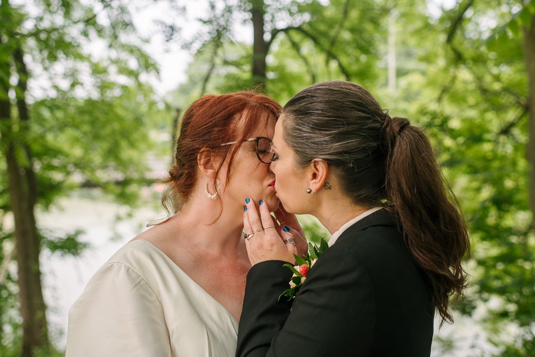Brides kissing each other
