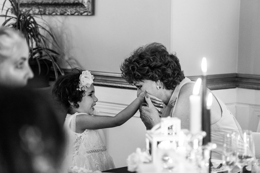 Grandma kissing granddaughters hands on her daughter wedding