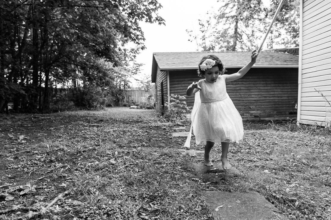Black and white picture of a little girl walking bare foot.