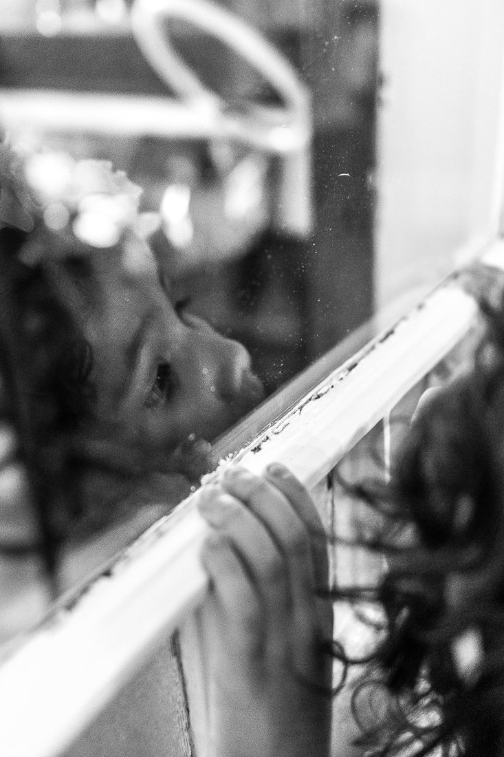 Girl child looking at the mirror, black and white image
