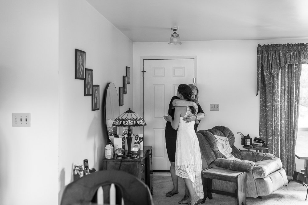 Black and white picture of bride hugging her mom