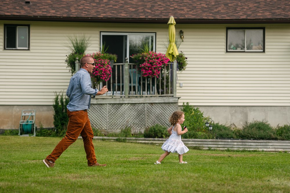 Cute little girl and her father running in the wedding venue