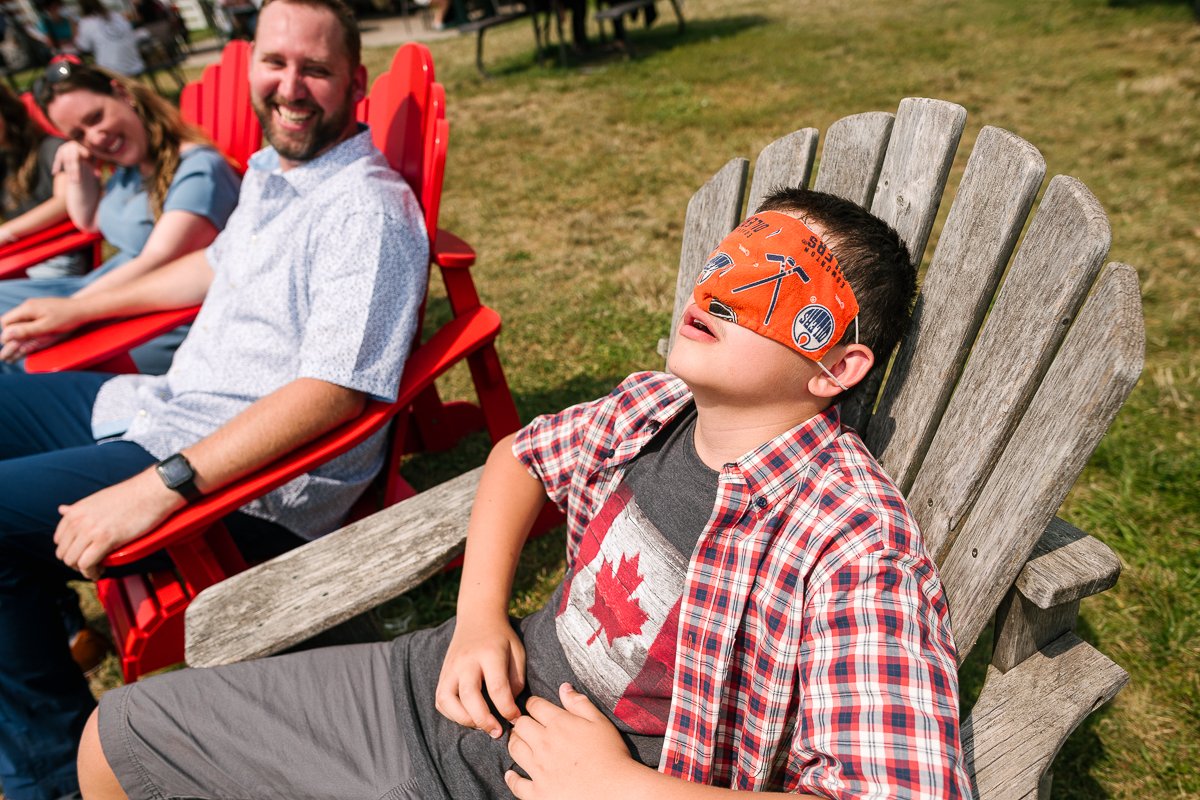 Boy sitting with face mask enjoying sun