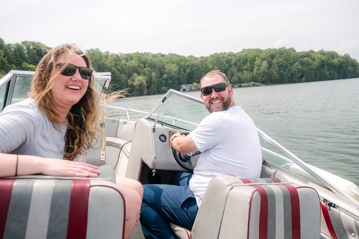Couple enjoying riding the boat wearing glasses.