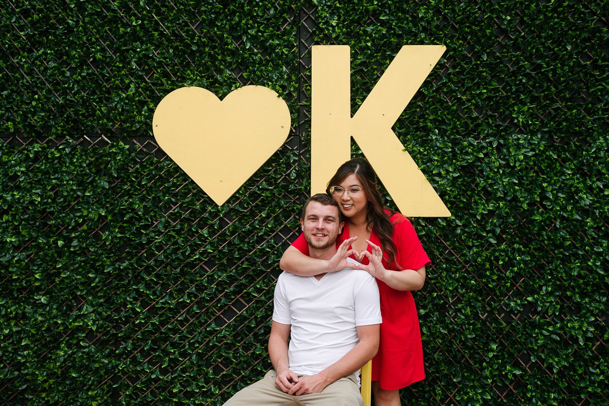 Couple posing with sign heart