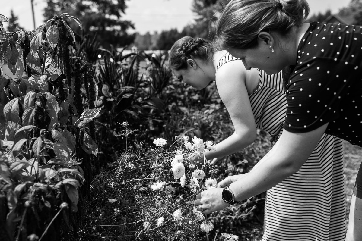 Black and white picture of women collecting flowers