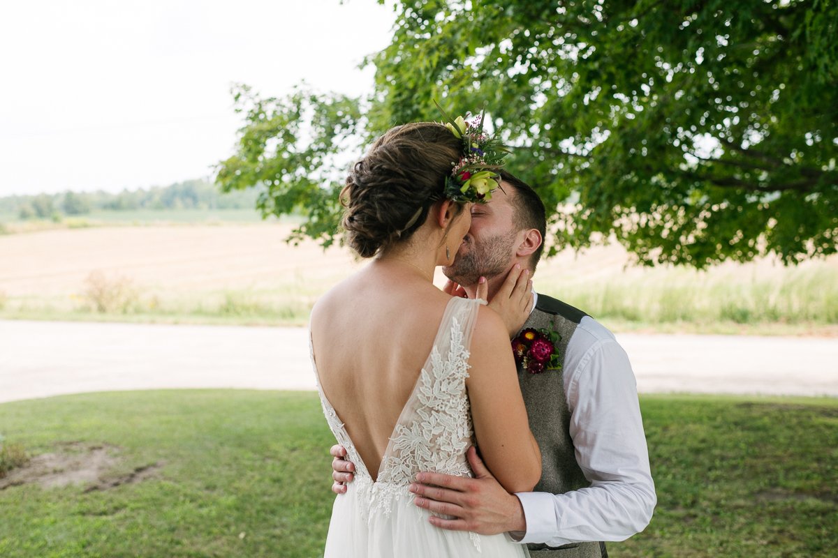 Couple kissing each other on their wedding day.