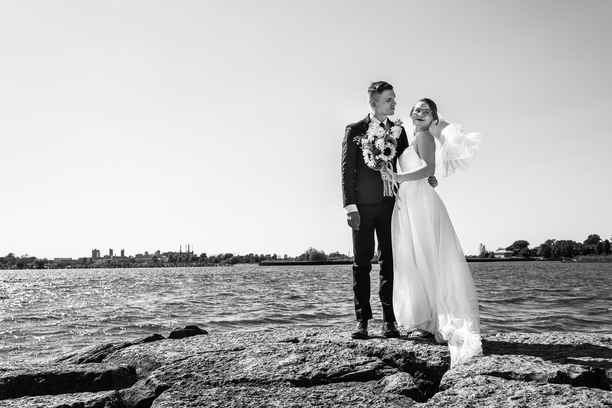 Black and white image of Bride and groom walking after their wedding. 