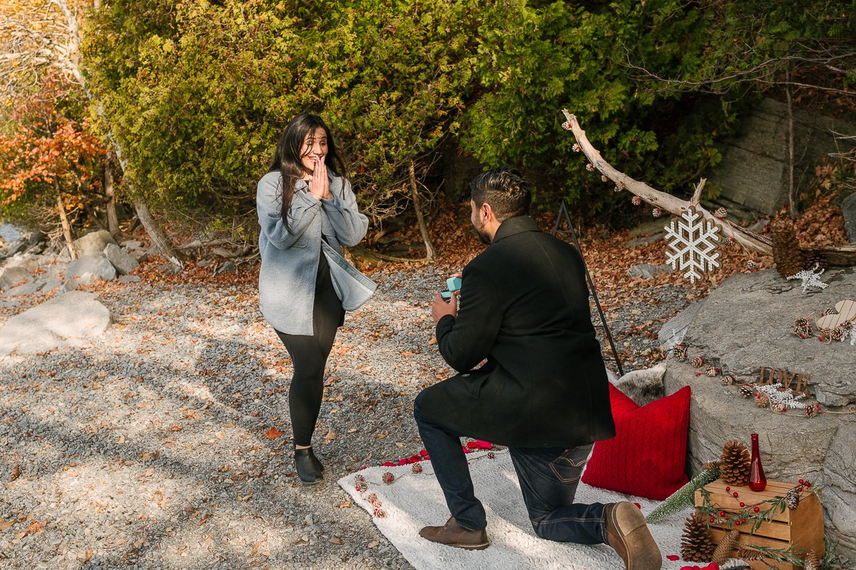 Woman surprised on receiving surprise proposal.