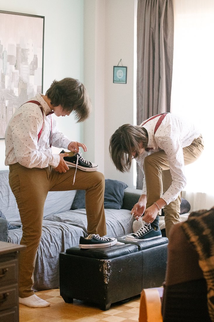 Boys getting ready wearing shoes for the wedding function