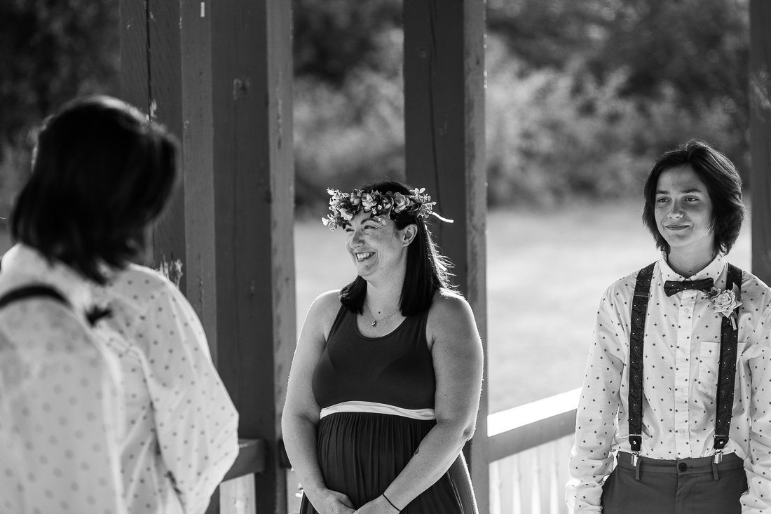 Black and white image of bride and her kids during wedding ceremony