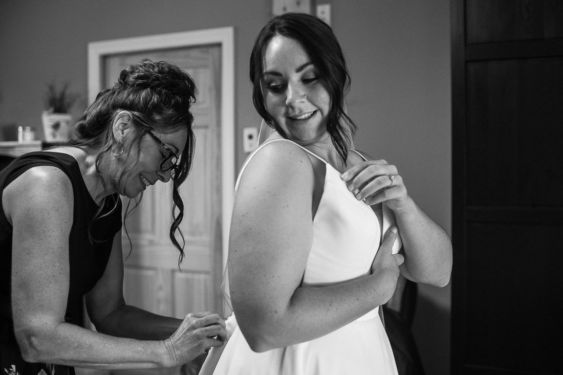 Black and white image of bride getting ready. 
