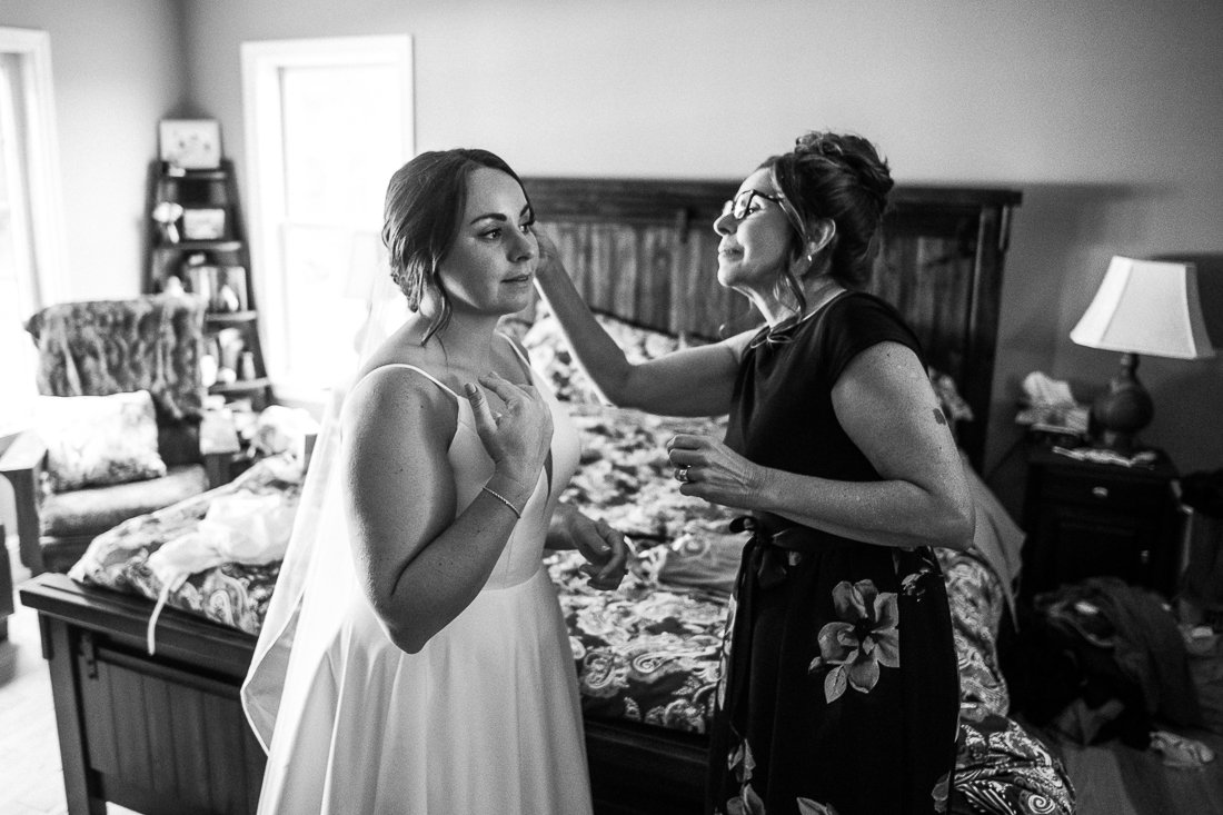 Black and white image of bride getting ready. Outdoor wedding ceremony bride in white 