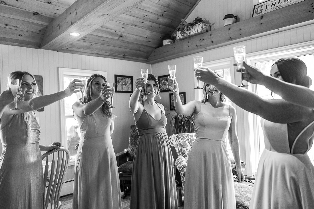 Black and white image of bride meeting her bridesmaid.