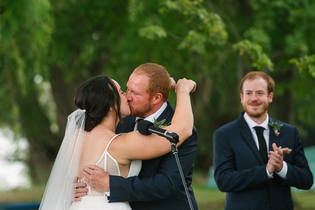 bride and groom kissing after the wedding