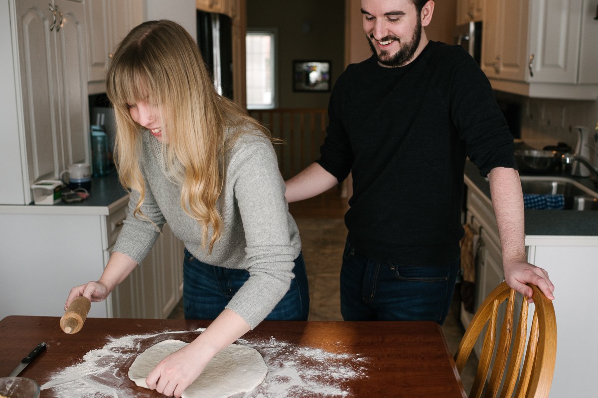 Couple making perogies together on their engagement session.