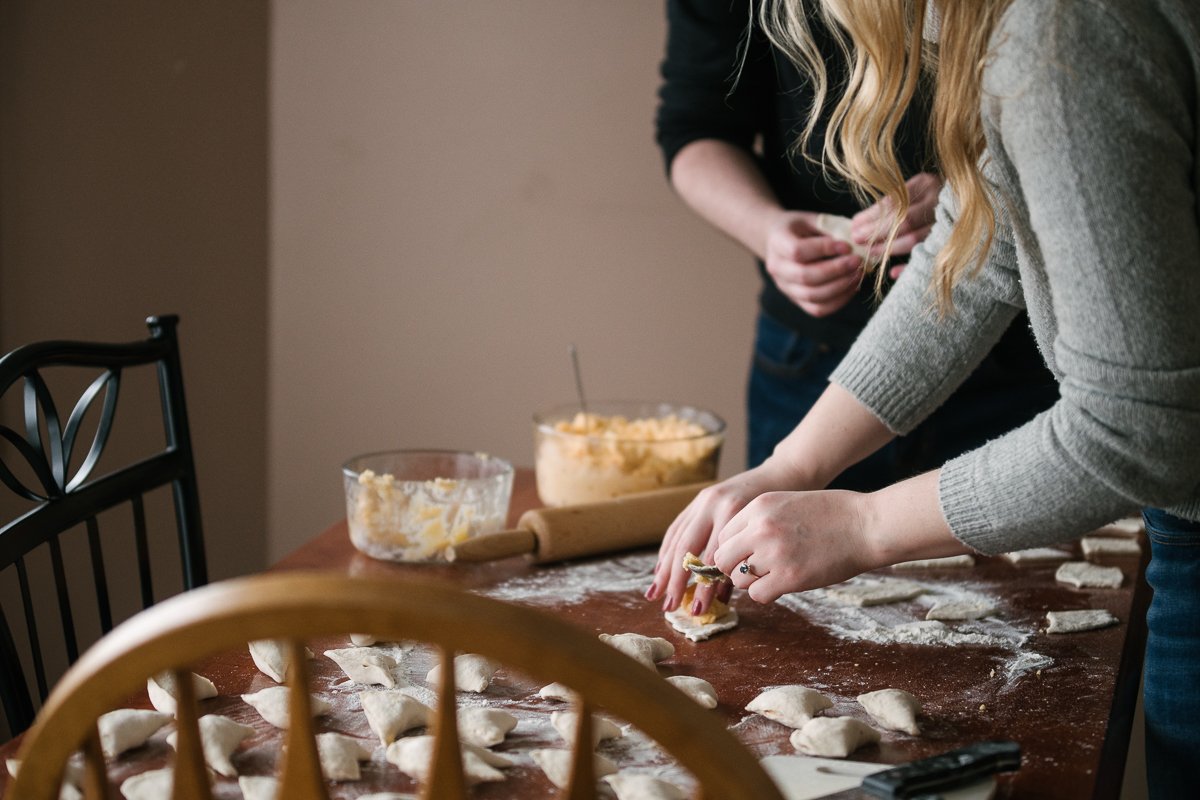 Couple making perogies together on their engagement session.