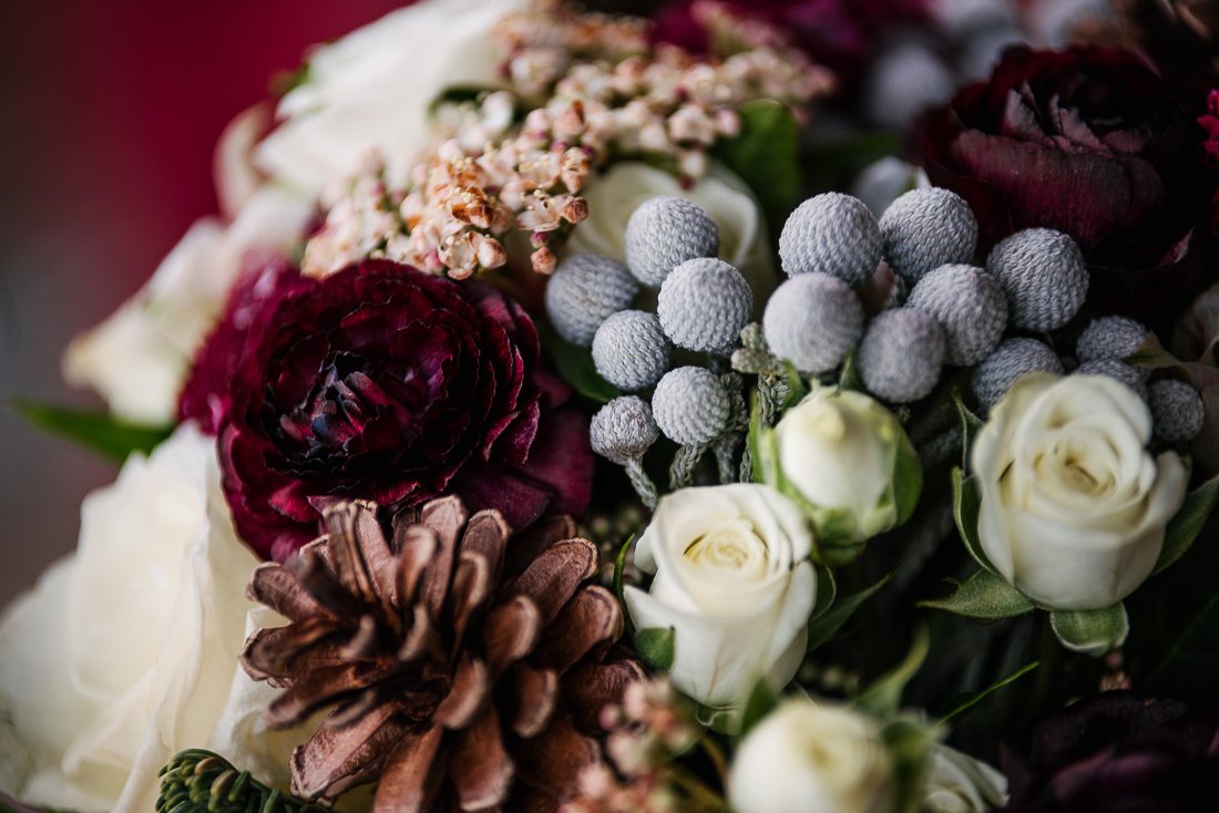 Maroon, cream and purple flowers in the bouquet