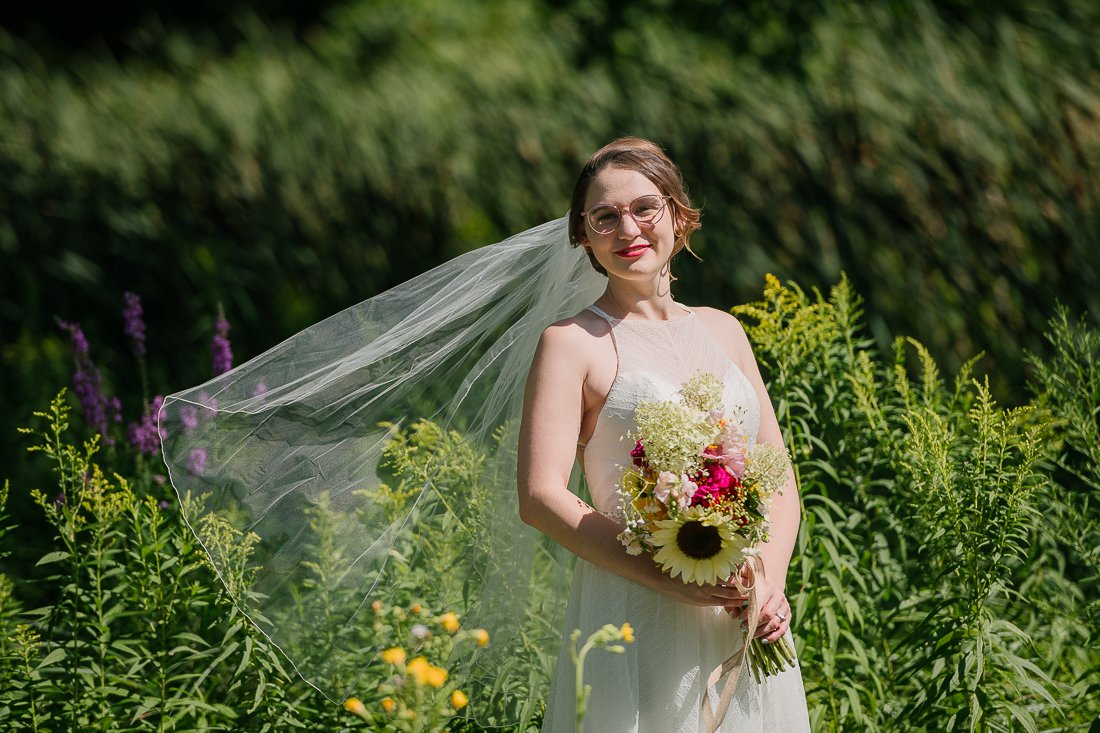 Bride in the garden with her flower bouquet