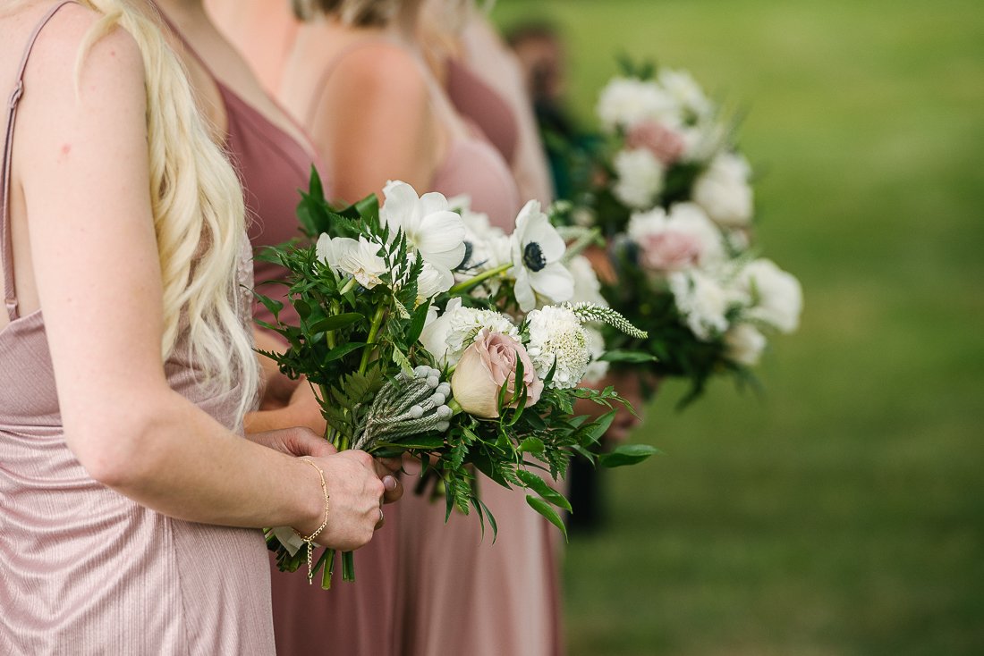 Bridesmaids holding beautiful flower bouquets
