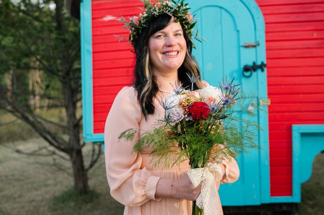 Bride holding flower bouquet and wearing flower tiara