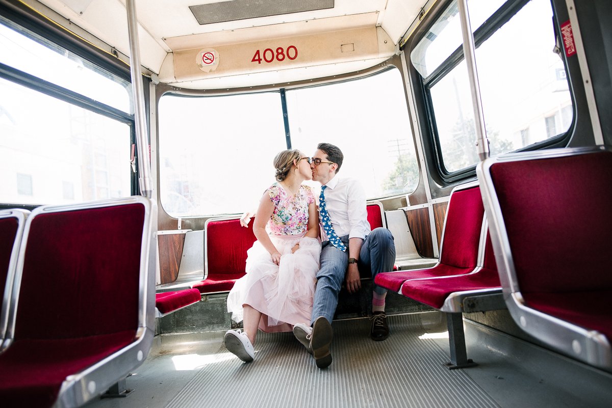 Bride and groom kissing in the bus