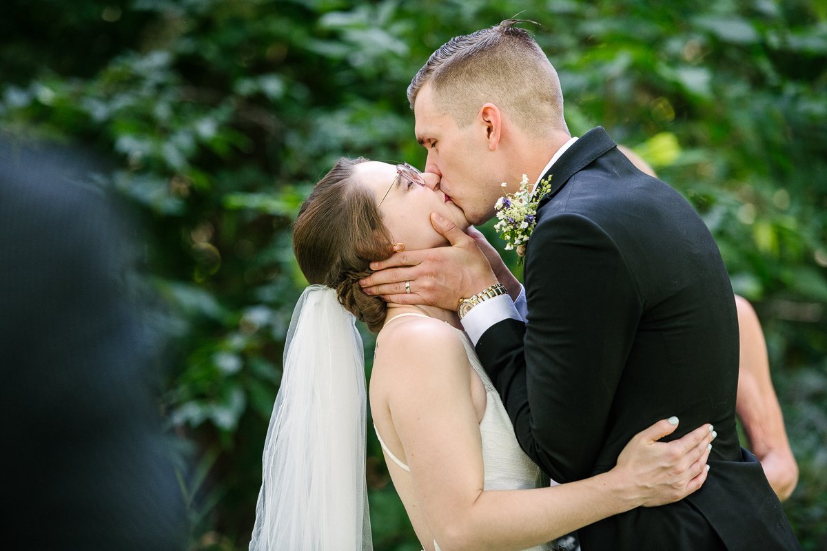 Bride and groom kissing passionately