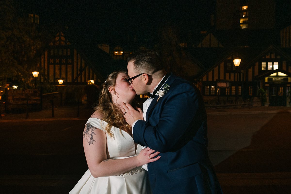 Bride and groom kissing in the night