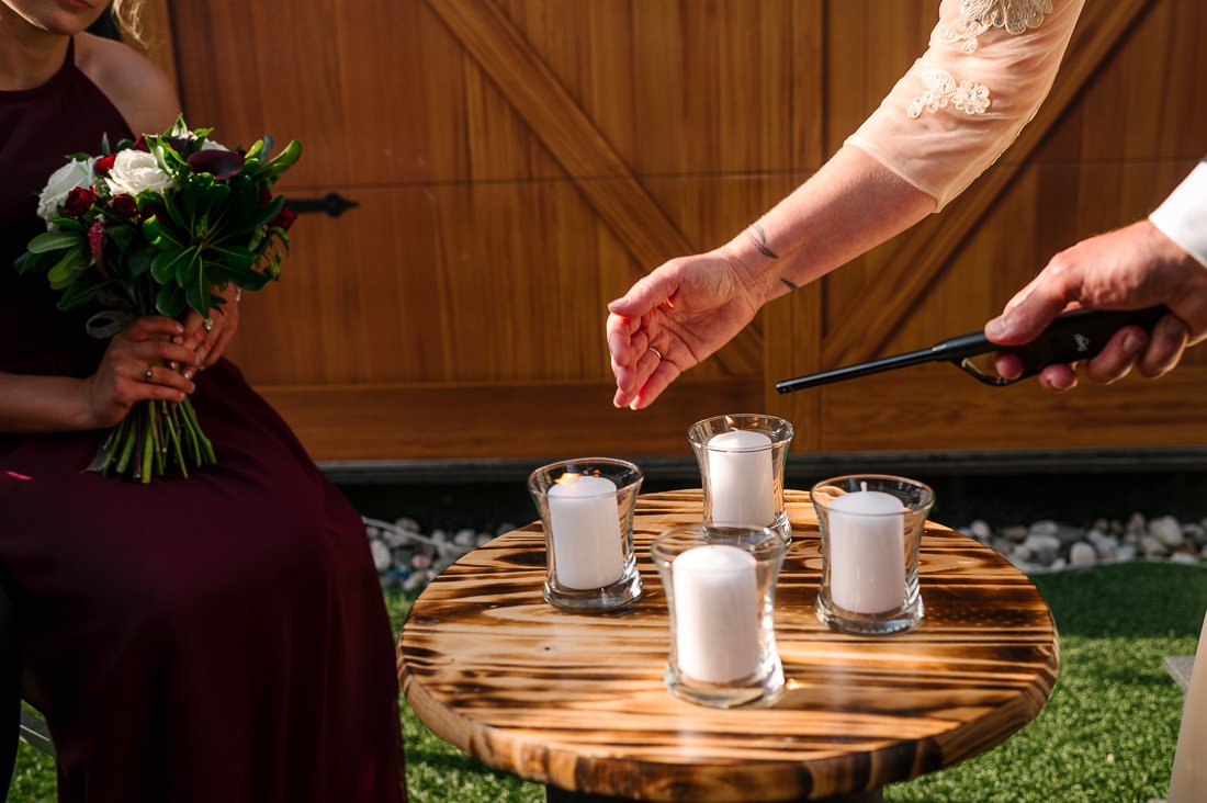 Couple celebrating their wedding event lighting candles. 