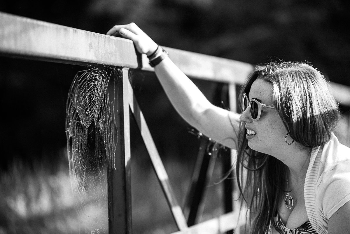 Black and white picture of girl seeing the spider net.