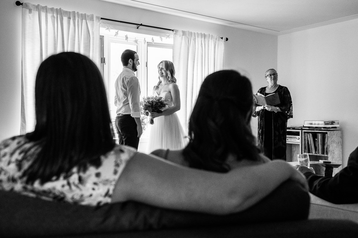 Black and white picture of bride and groom taking vows.