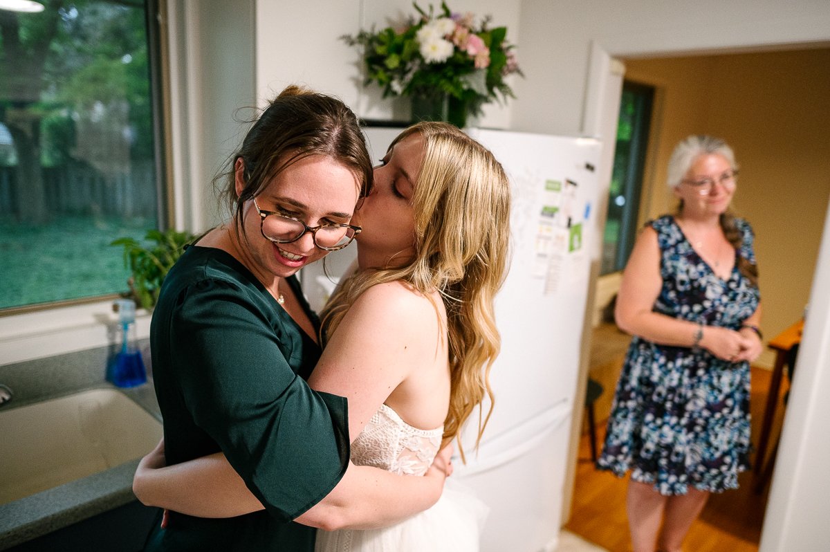 Bride hugging her sister at her wedding function.