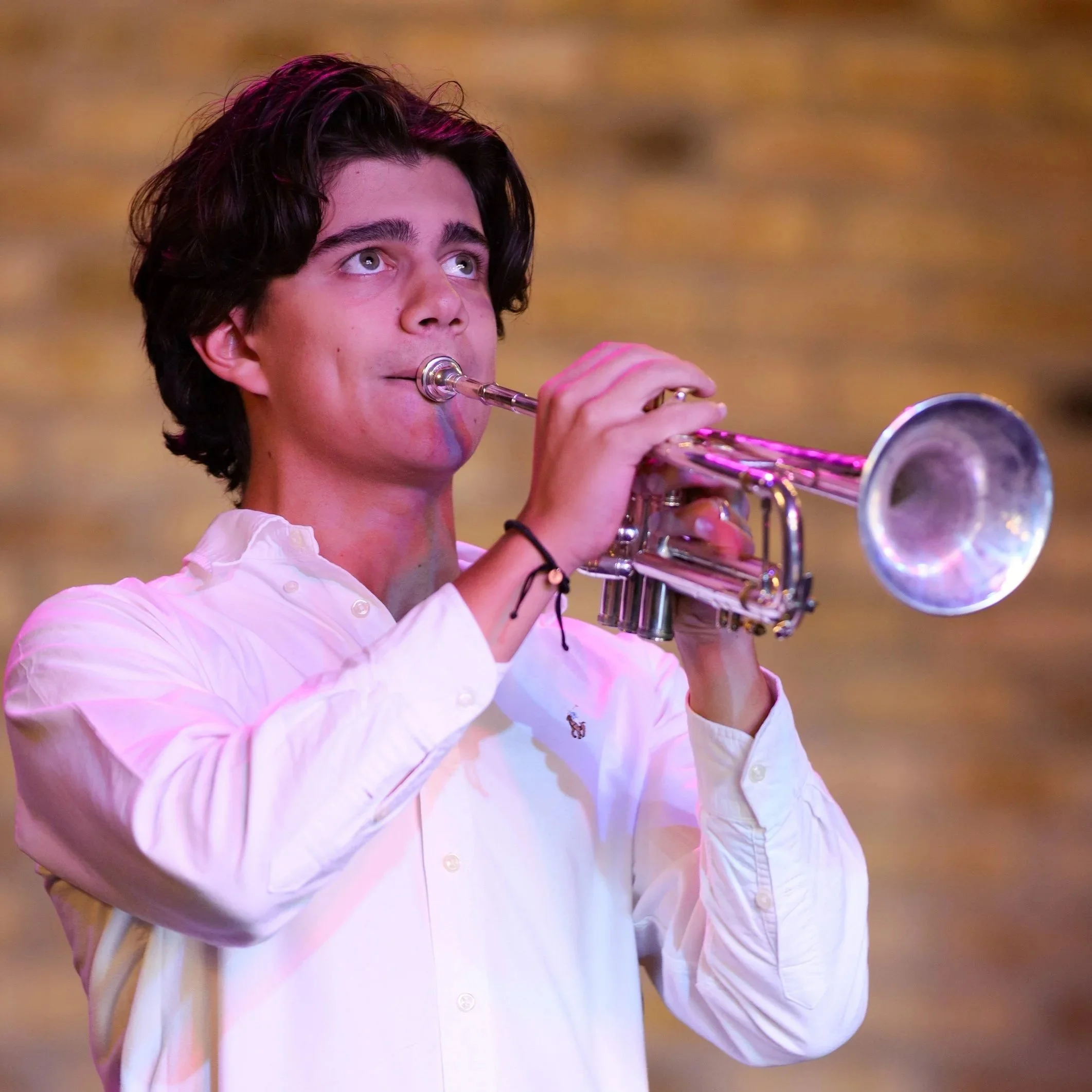 male student playing the trumpet