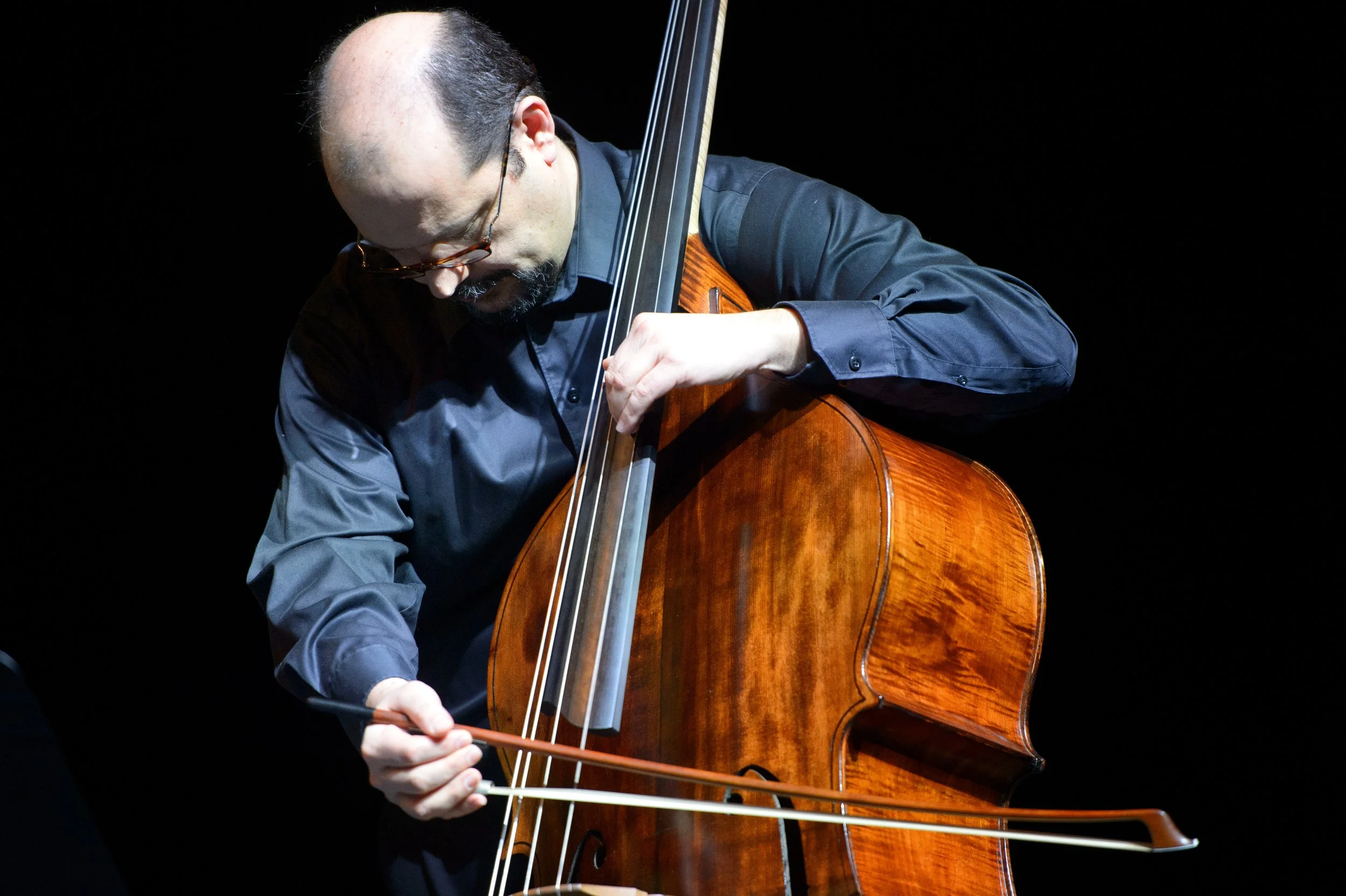 A middle aged man with a cello