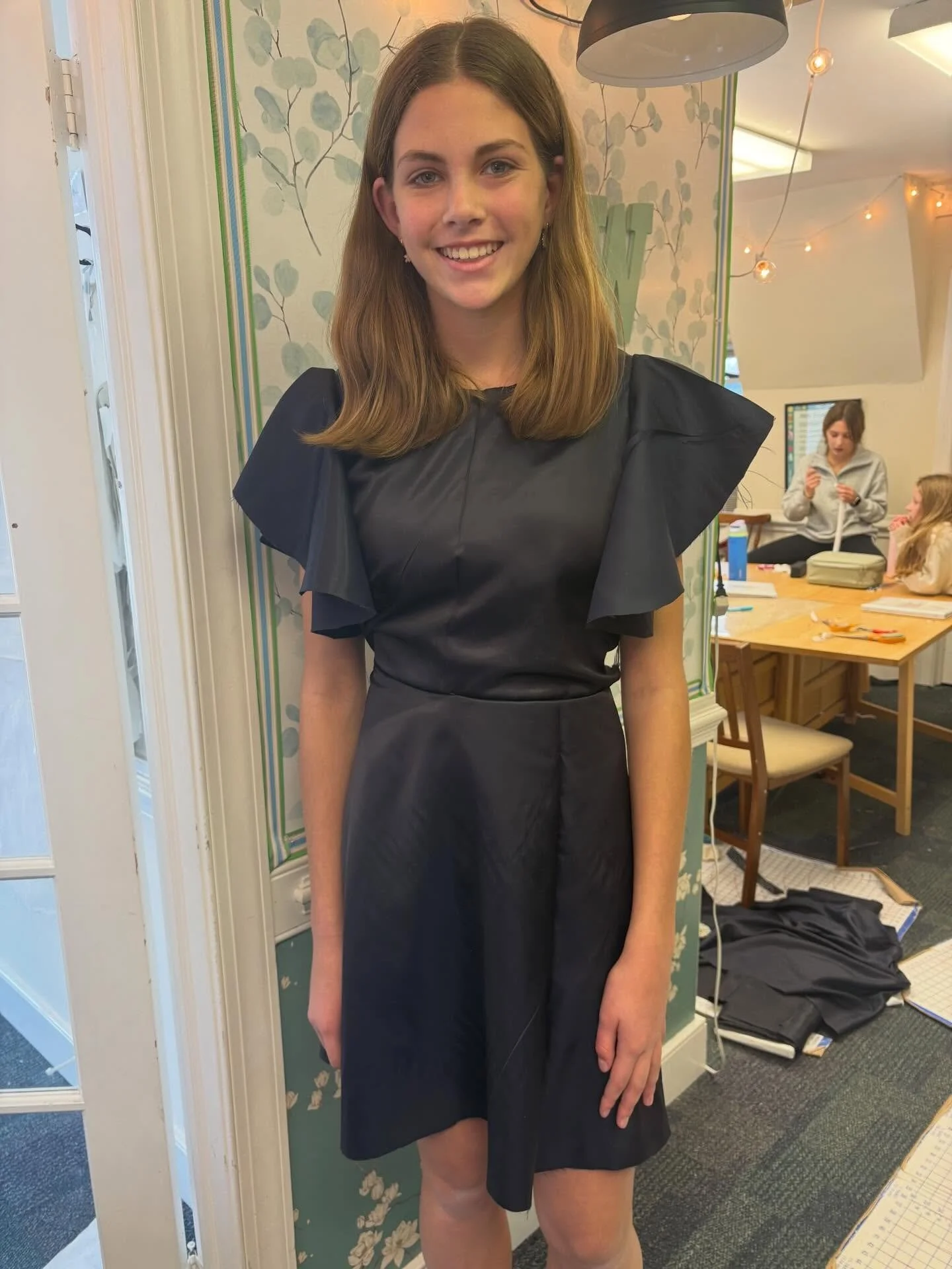 A look into our snow day mini workshop:
The first pictured blue ruffle dress with flounce sleeves was made with a slippery fabric that is not stretchy and therefore harder to fit and sew. She did a great job piecing it together. 

Next up a flower pr