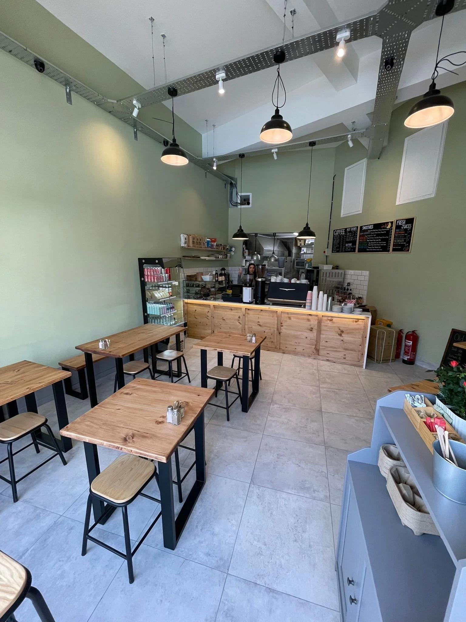 Bespoke solid wood café tables, stools and counter front made by Artemis London for Oval Café in London  For the front