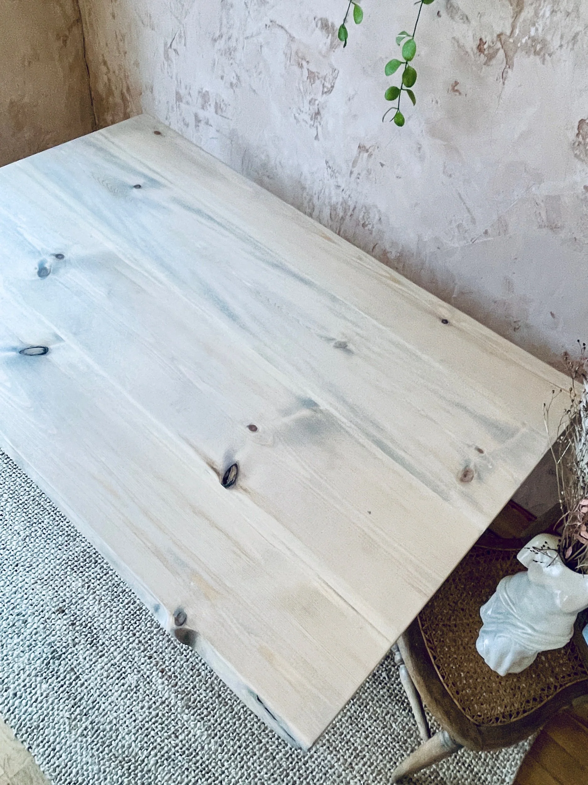 Top-down shot of light wood tabletop showing knots and natural grain pattern