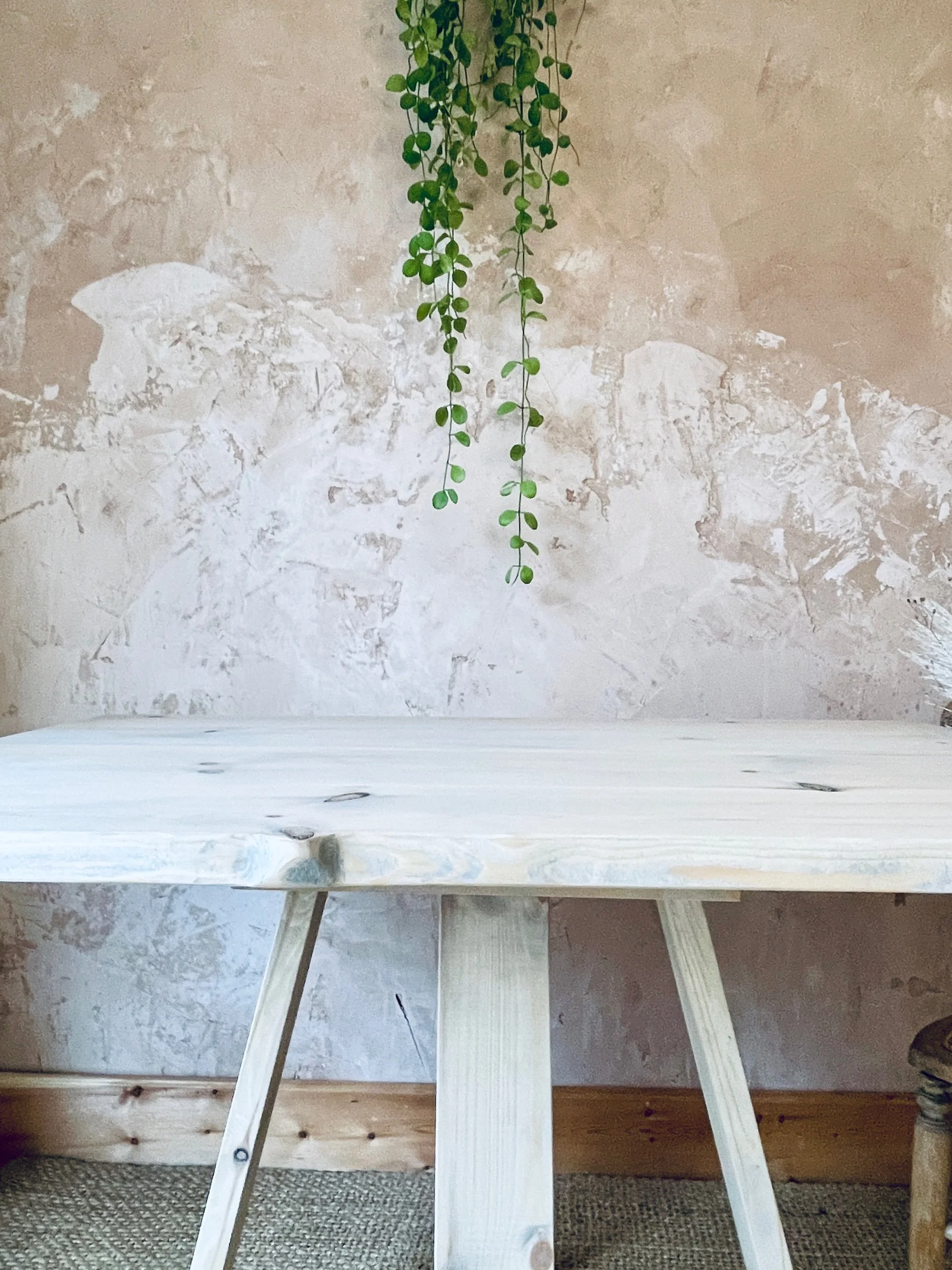 Minimalist room with plaster wall and light wooden tabletop surface