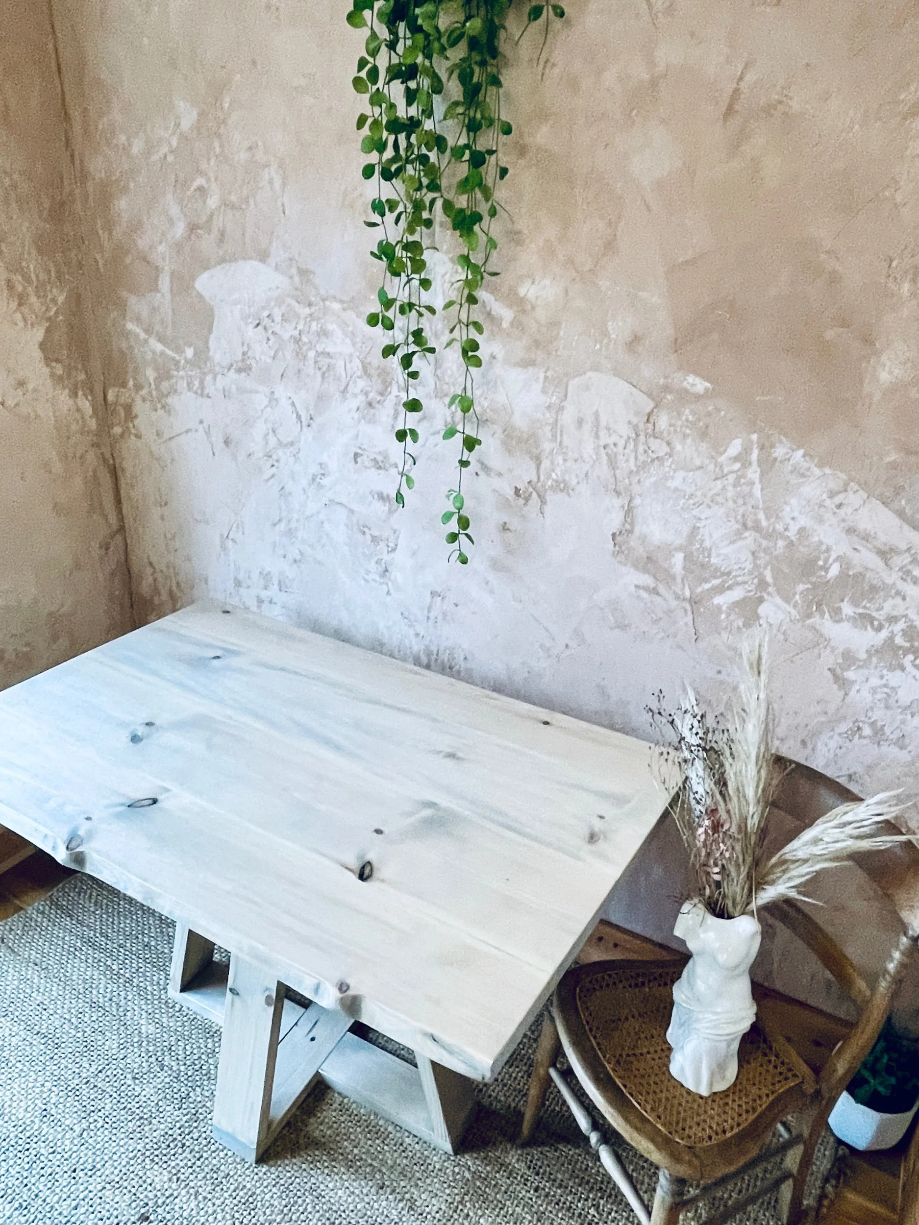 Light wood dining table photographed from above showing grain and knots