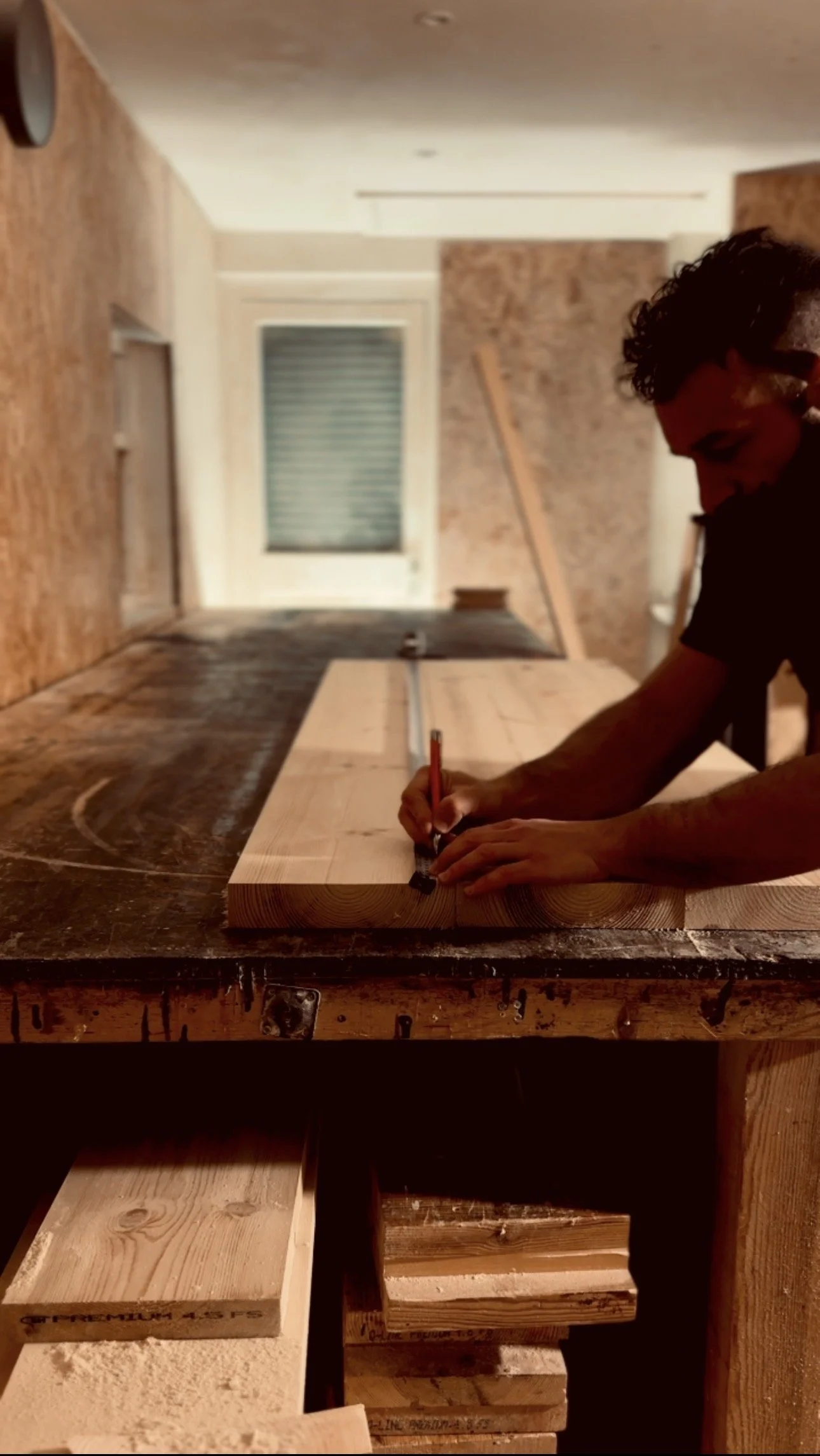 Marking and measuring solid Swedish redwood boards for a handmade desk in my workshop, Artemis London.