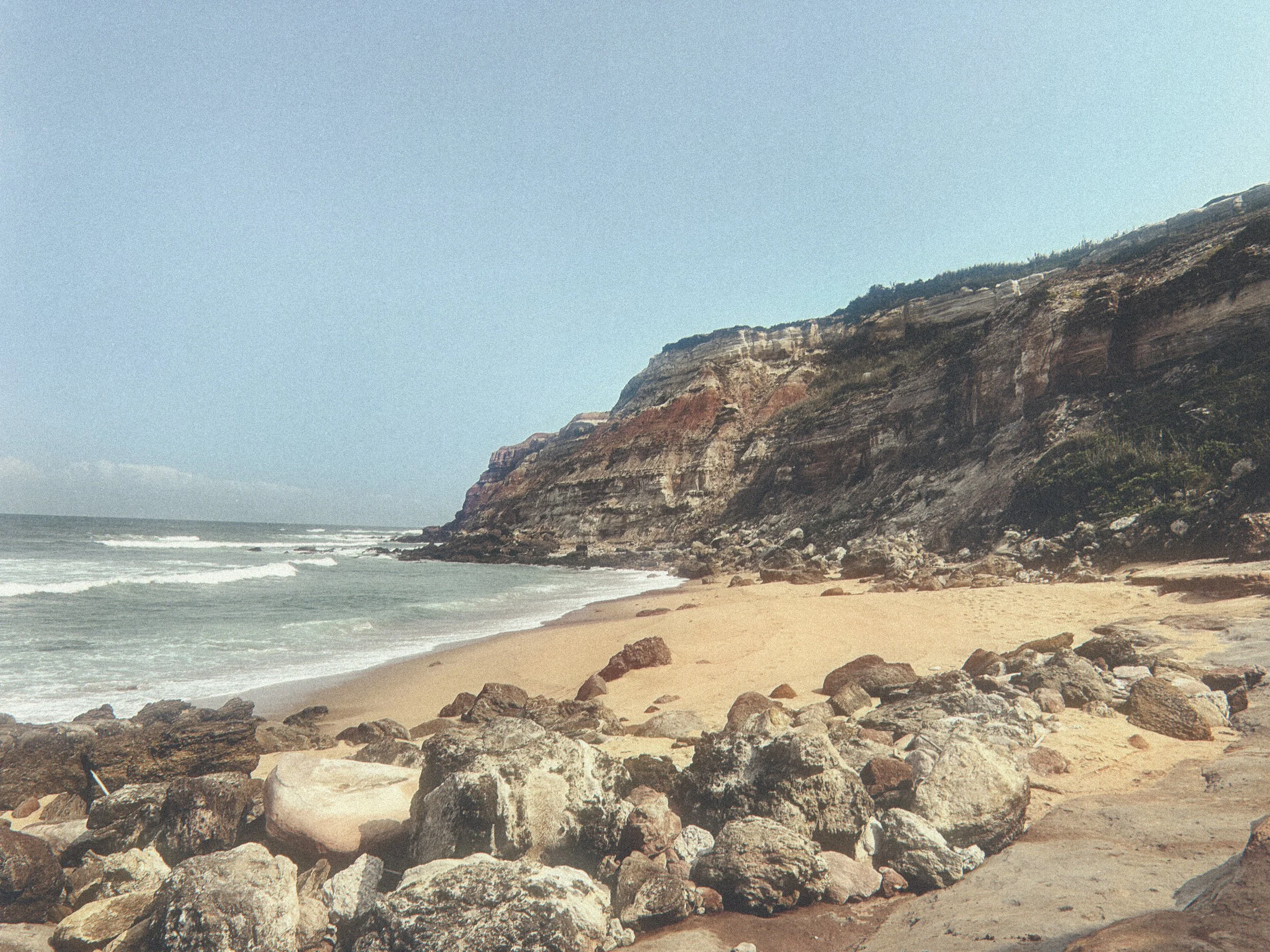 Atlantic ocean and cliff trails below Blanco Bungalow, Ericeira Portugal