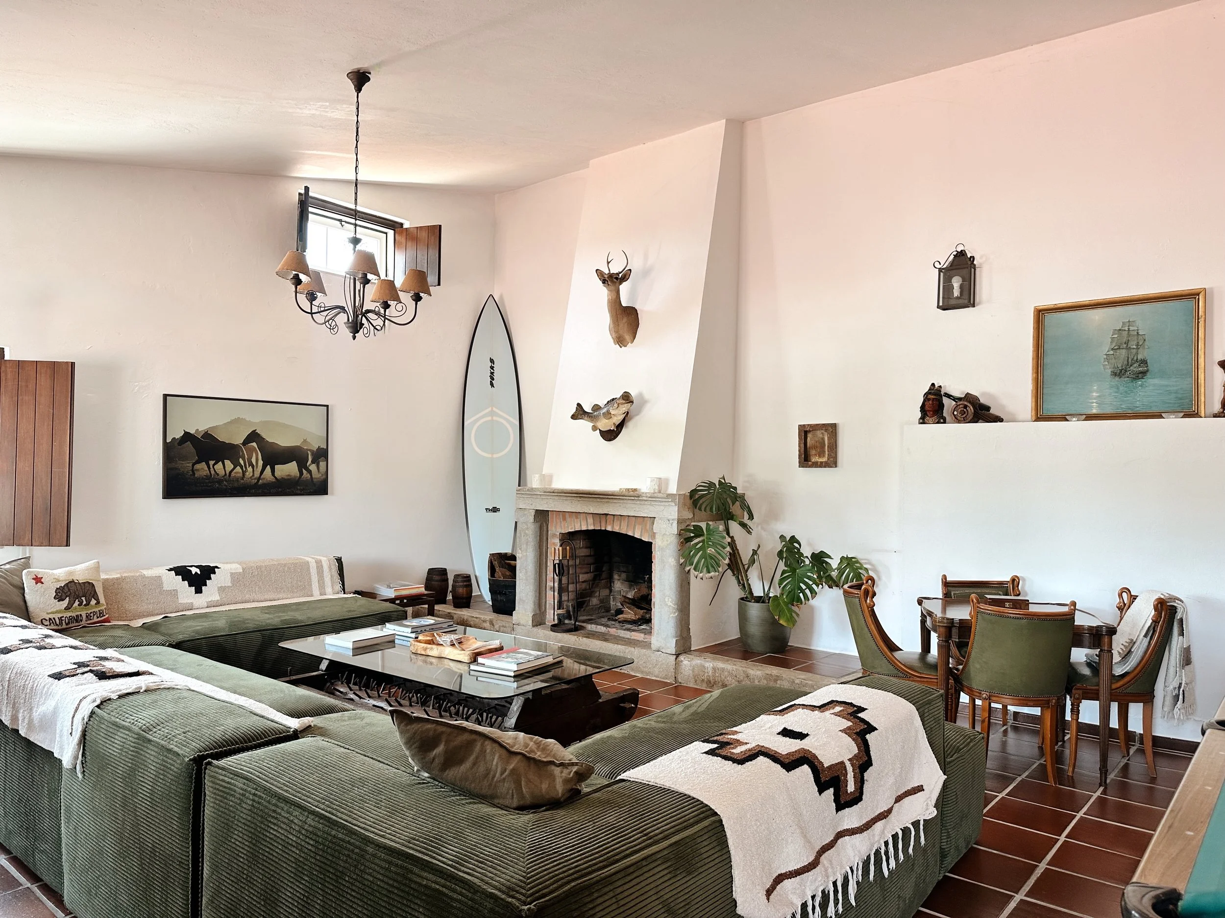 Poolhouse with fireplace, pool table, poker table, and long dinner table at Blanco Bungalow, Ericeira