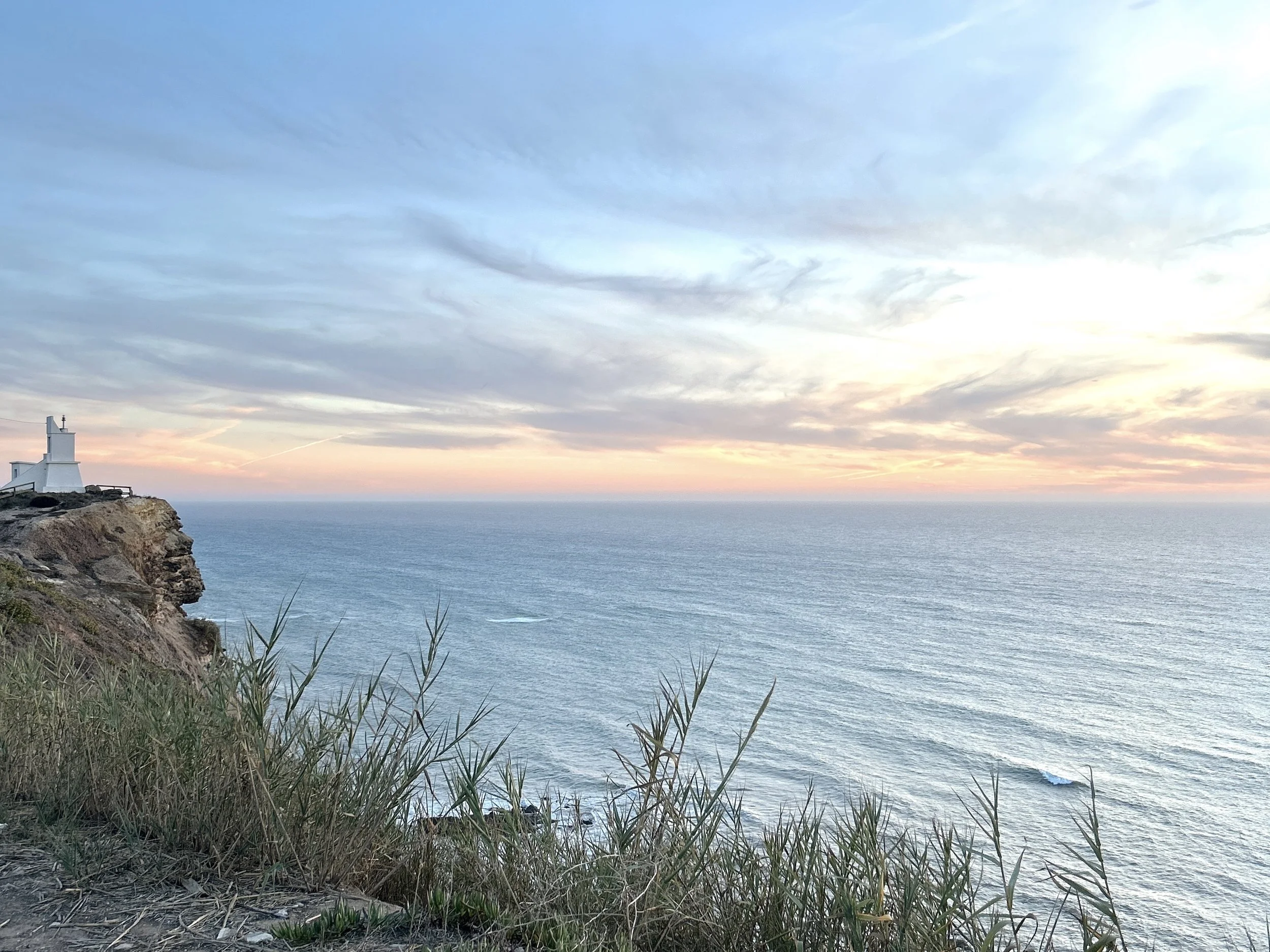 Atlantic ocean and cliff trails below Blanco Bungalow, Ericeira Portugal