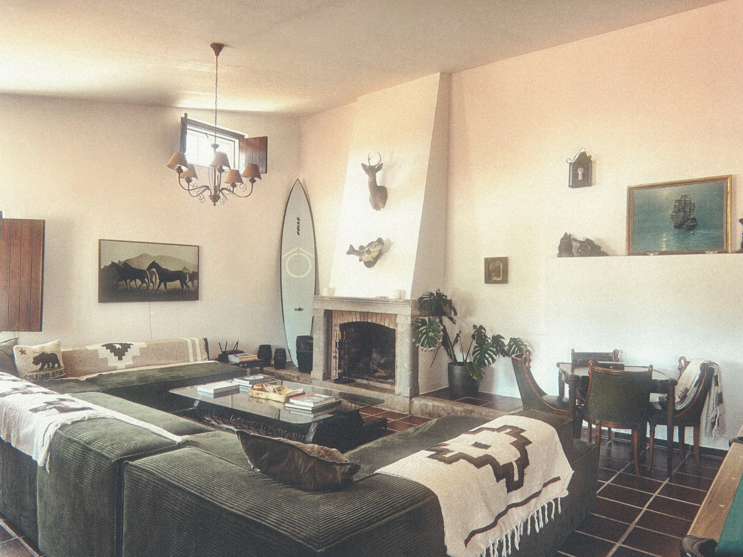 Poolhouse with fireplace, pool table, poker table, and long dinner table at Blanco Bungalow, Ericeira