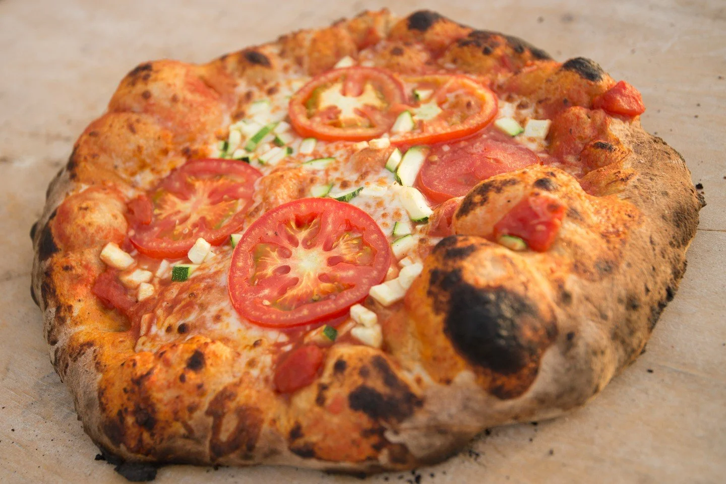 Wood-fired pizza is only as good as the dough you start with. Quality grain gives the crust structure and actual flavor&mdash;not just something to hold the toppings. When bakers pay attention to their flour, you can taste it. The crust blisters, dev
