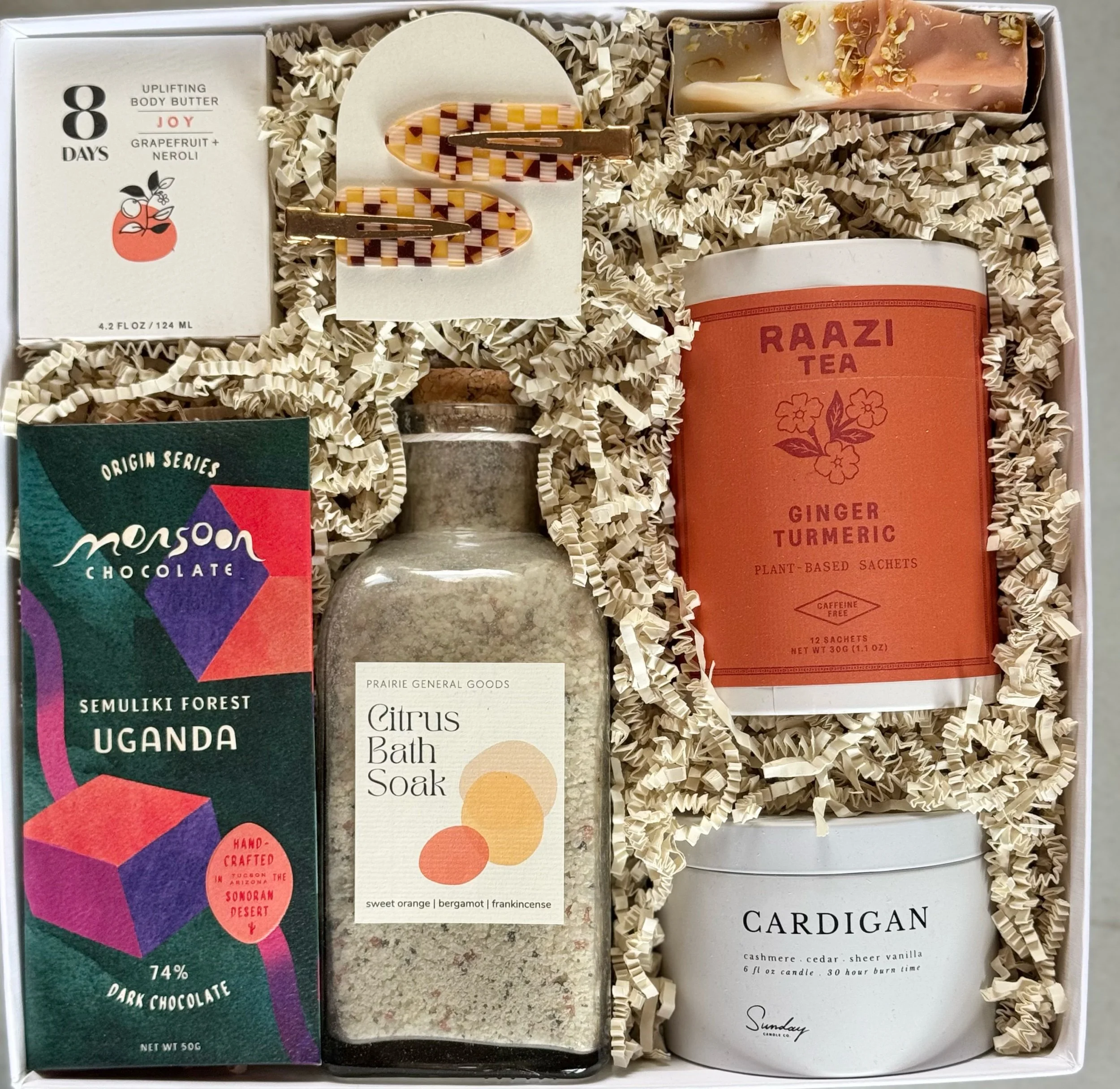 Sunflower luxury self care gift box with ginger turmeric tea, dark chocolate, citrus bath soak, and body care.