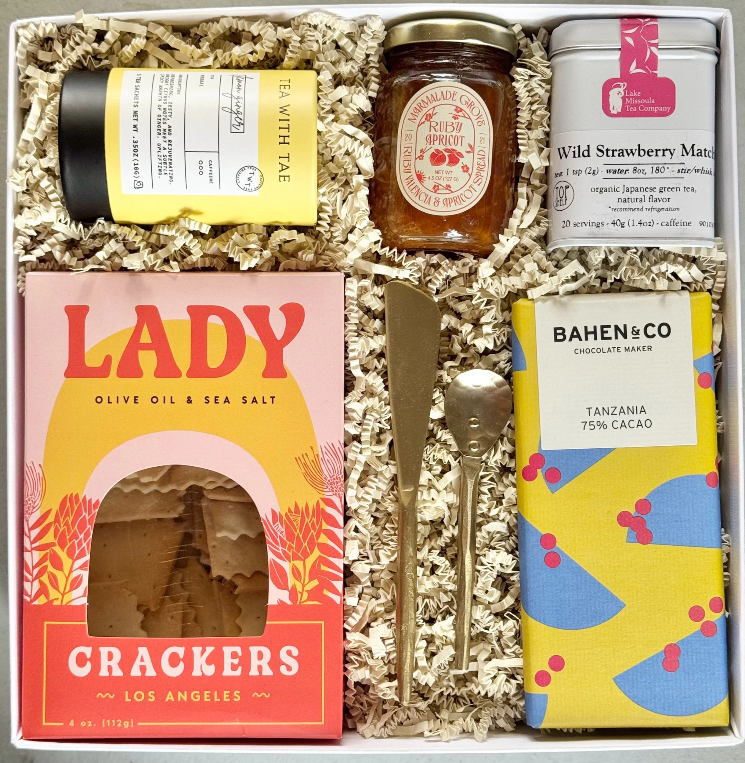 Picnic in the Park gourmet gift box with tea, strawberry matcha, marmalade, sourdough crackers and hammered gold utensils.